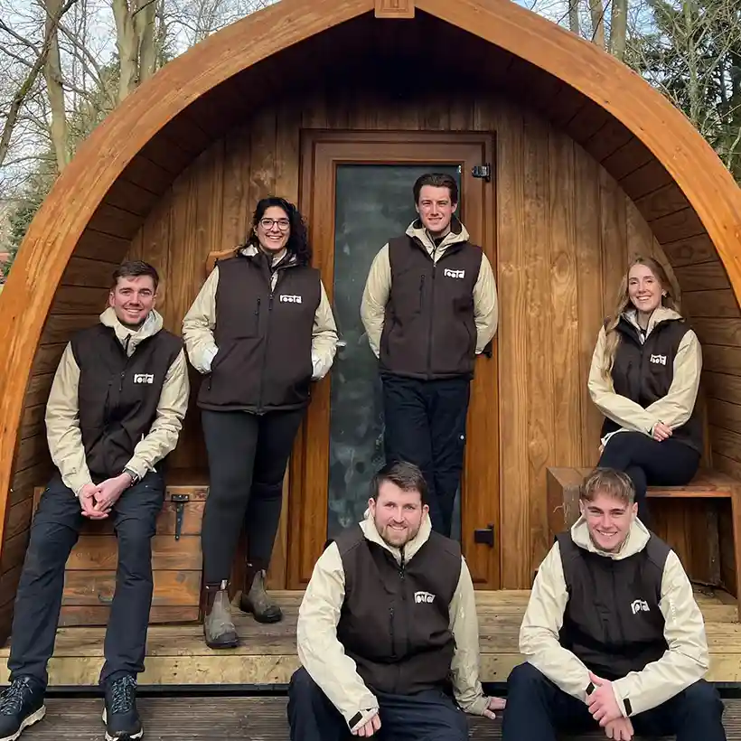 Rootd team standing outside a cabin