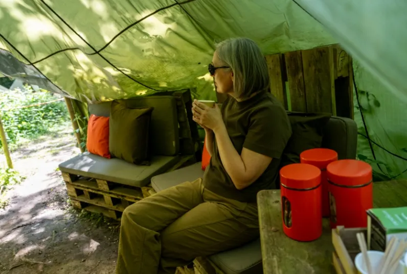 teacher enjoying a coffee in a residential adventure camp chill out area