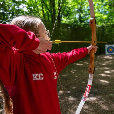 Enjoying archery on a residential school trip