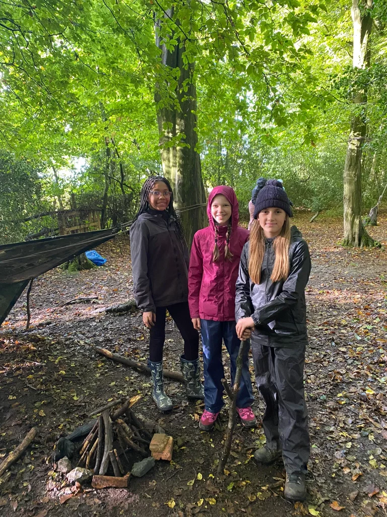 Girls smiling on a woodland school residential trip