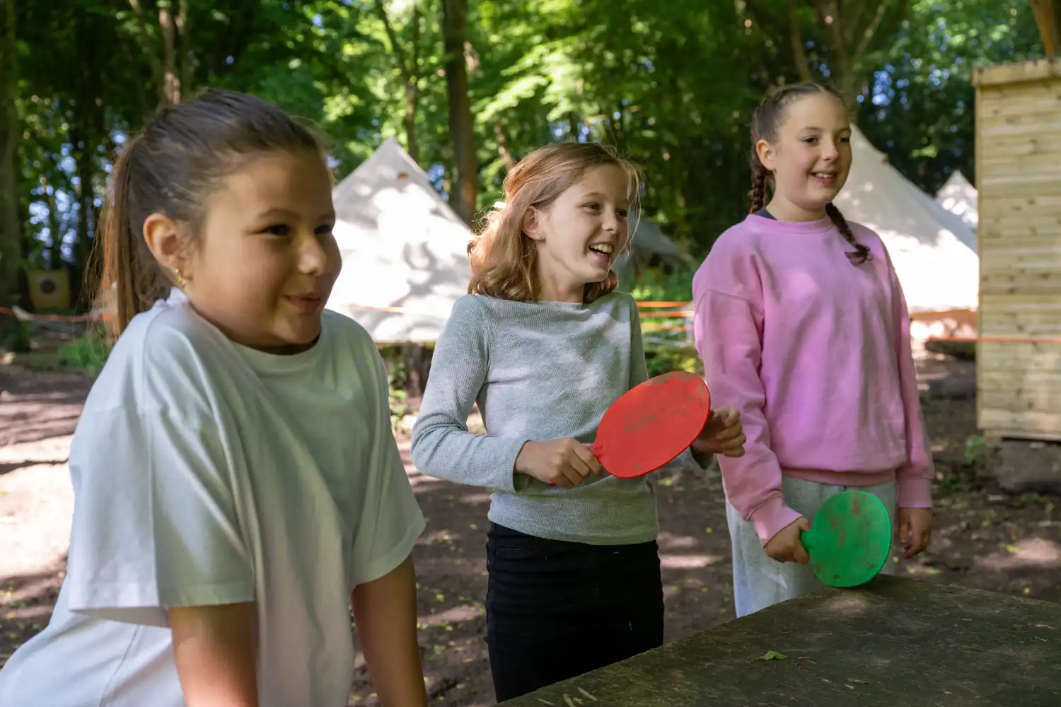 Girls playing outdoor table tennis