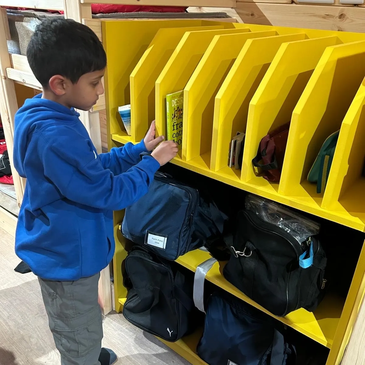 boy in pod choosing book