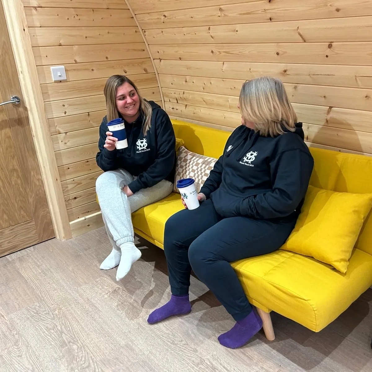 teachers drinking tea in pod accommodation